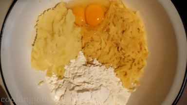 In a large bowl mix well together grated potatoes with mashed potatoes, eggs and flour mixture.
