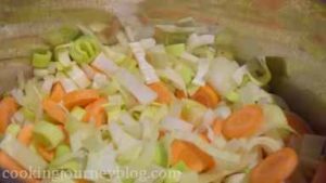 Add chopped garlic, leek and onion to the pot. Cook, stirring for a minute, then add vegetables.