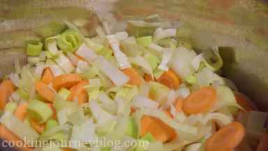 Add chopped garlic, leek and onion to the pot. Cook, stirring for a minute, then add vegetables.