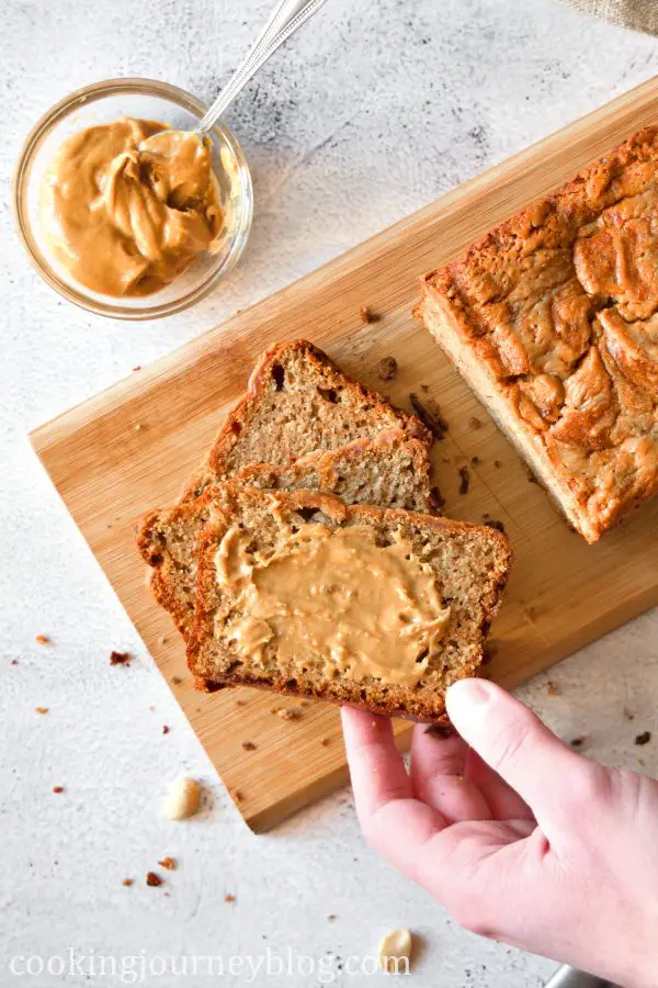 Grabbing a slice of peanut butter banan bread with peanut butter on top