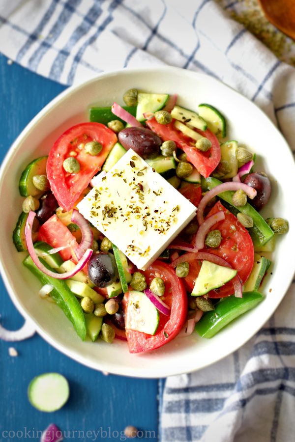 Horiatiki Greek salad with vegetables and feta in a white bowl