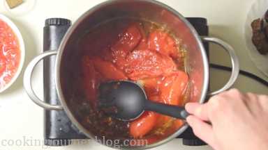 Add canned tomatoes. Crush with the back of the spoon.