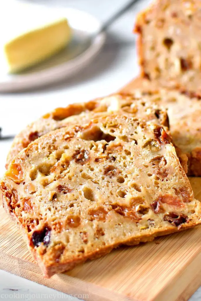 A slice of Irish Barmbrack on the wooden board