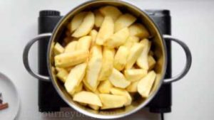 Put all apple slices in the large pot. Put the pot on the high heat.