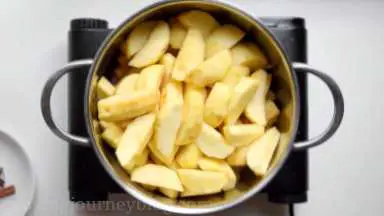 Put all apple slices in the large pot. Put the pot on the high heat.