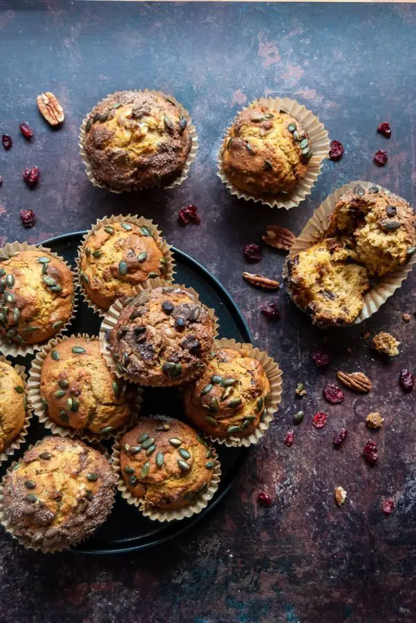 Muffins with nuts, dried raisins and pumpkin seeds on the dark table