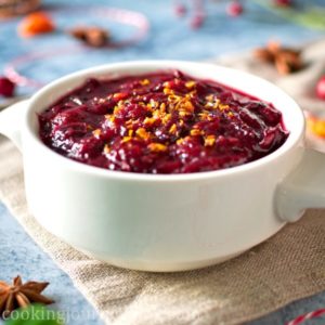 Vegan Cranberry Sauce recipe - served with orange zest in a white sauce plate