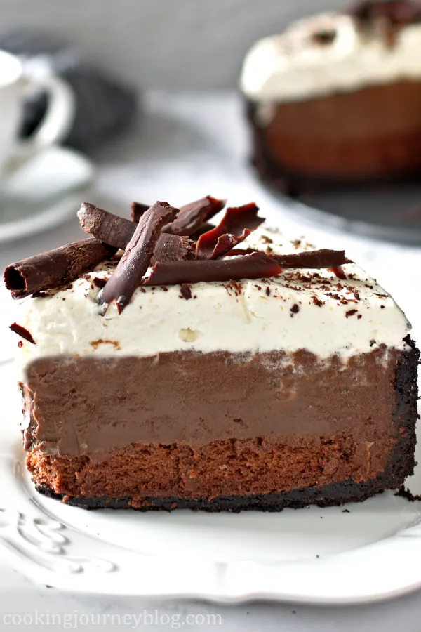 A slice of Mississippi Mud Pie with 3 layers served on a white plate