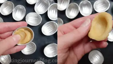 Put the dough ball in the walnut shell and push with your fingers. You should make thin skin on each walnut shell and cover the sides, because it will shrink, when baking.