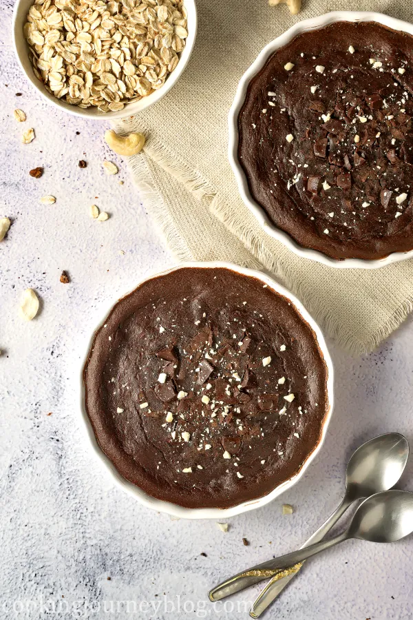 Chocolate baked oats served with crushed cashews