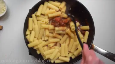 Add drained al dente pasta to the beef sauce and combine.