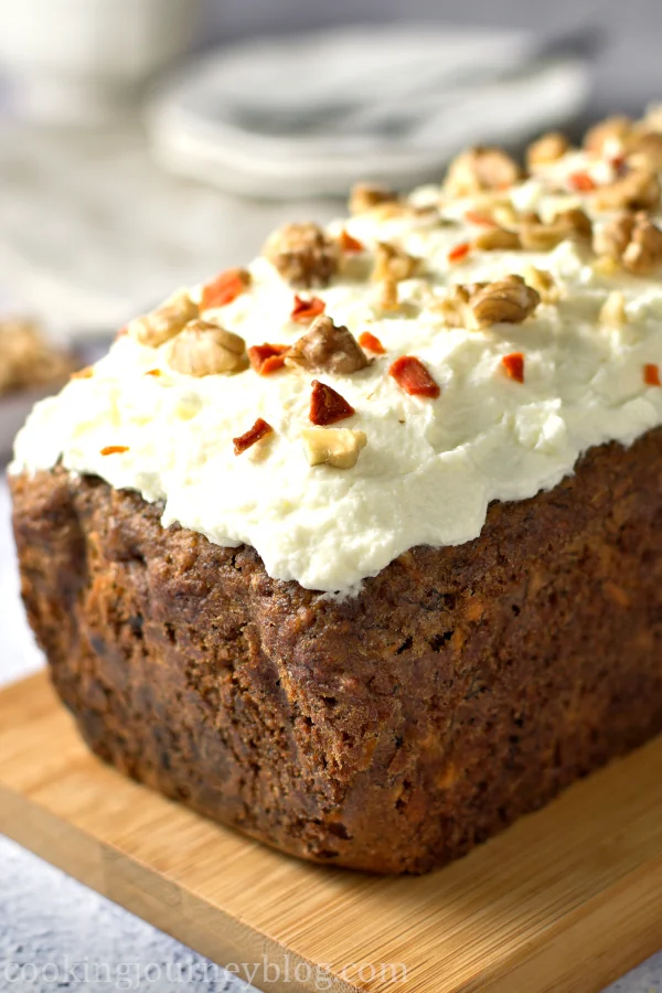Banana Carrot Bread with whipped topping and walnuts.