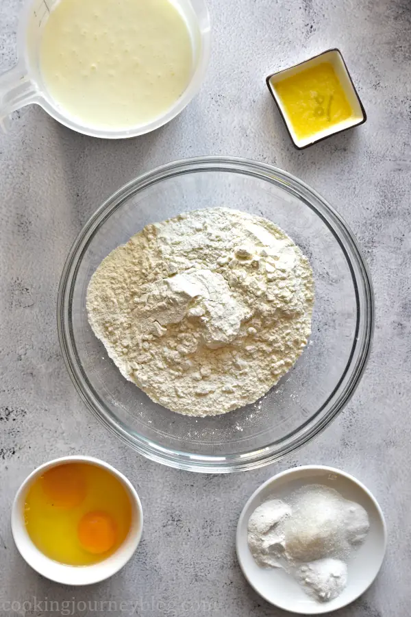 Ingredients for buttermilk pancakes: buttermilk, melted butter, flour, eggs, baking powder, baking soda, sugar and salt