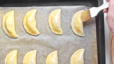Put the empanadas on the baking sheet, brush with an extra egg and bake 15-18 minutes until golden brown.