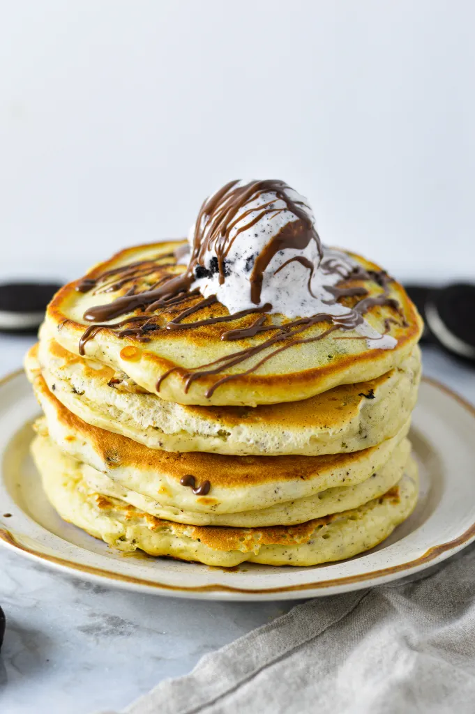 Fluffy pancakes, served with ice cream and drizzle of chocolate