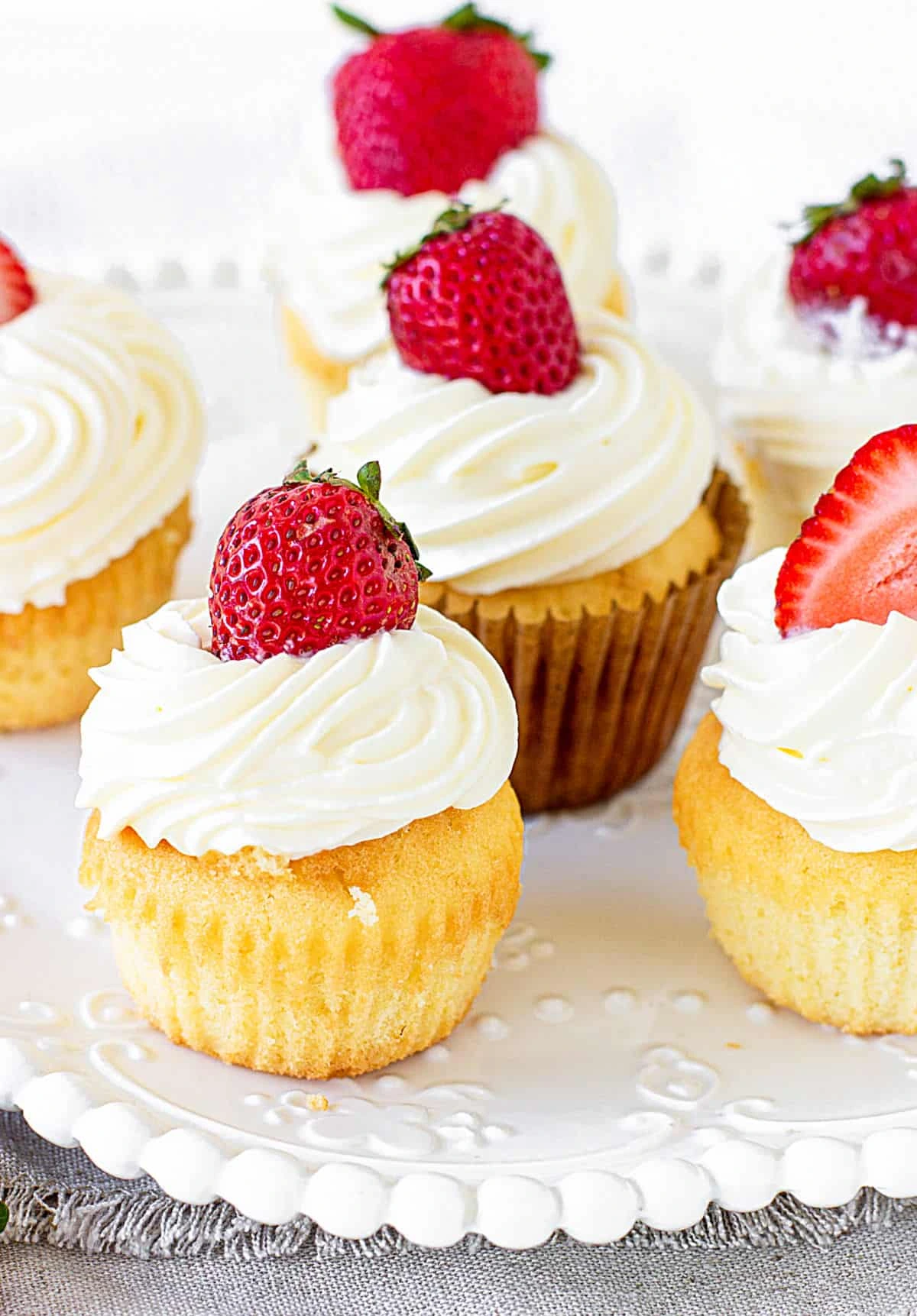 Strawberry Shortcake Cupcakes with cream and strawberry on top