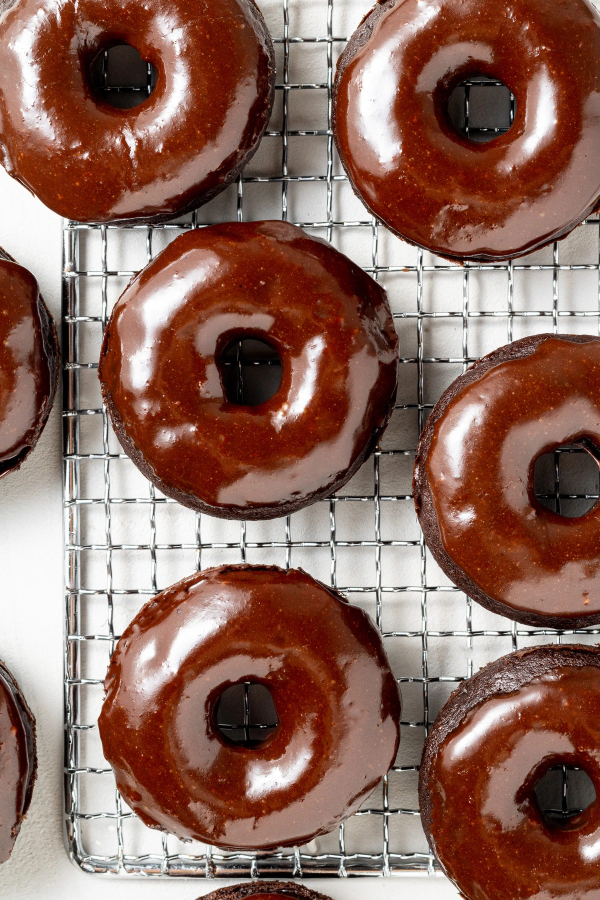 Donuts with chocolate glaze on a cooling rack