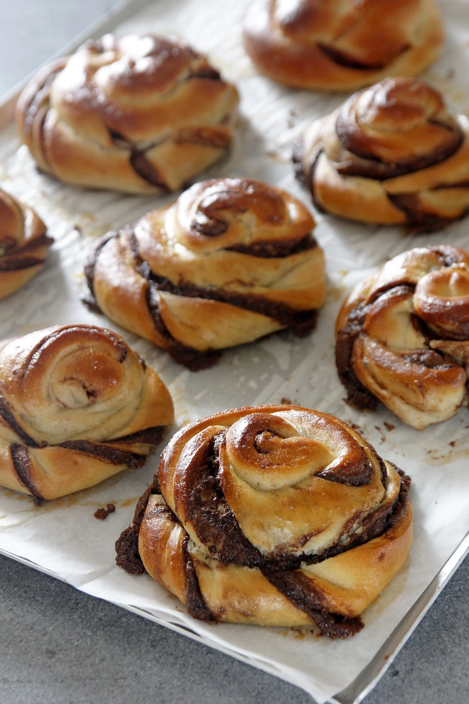 Baked chocolate rolls on a parchment paper