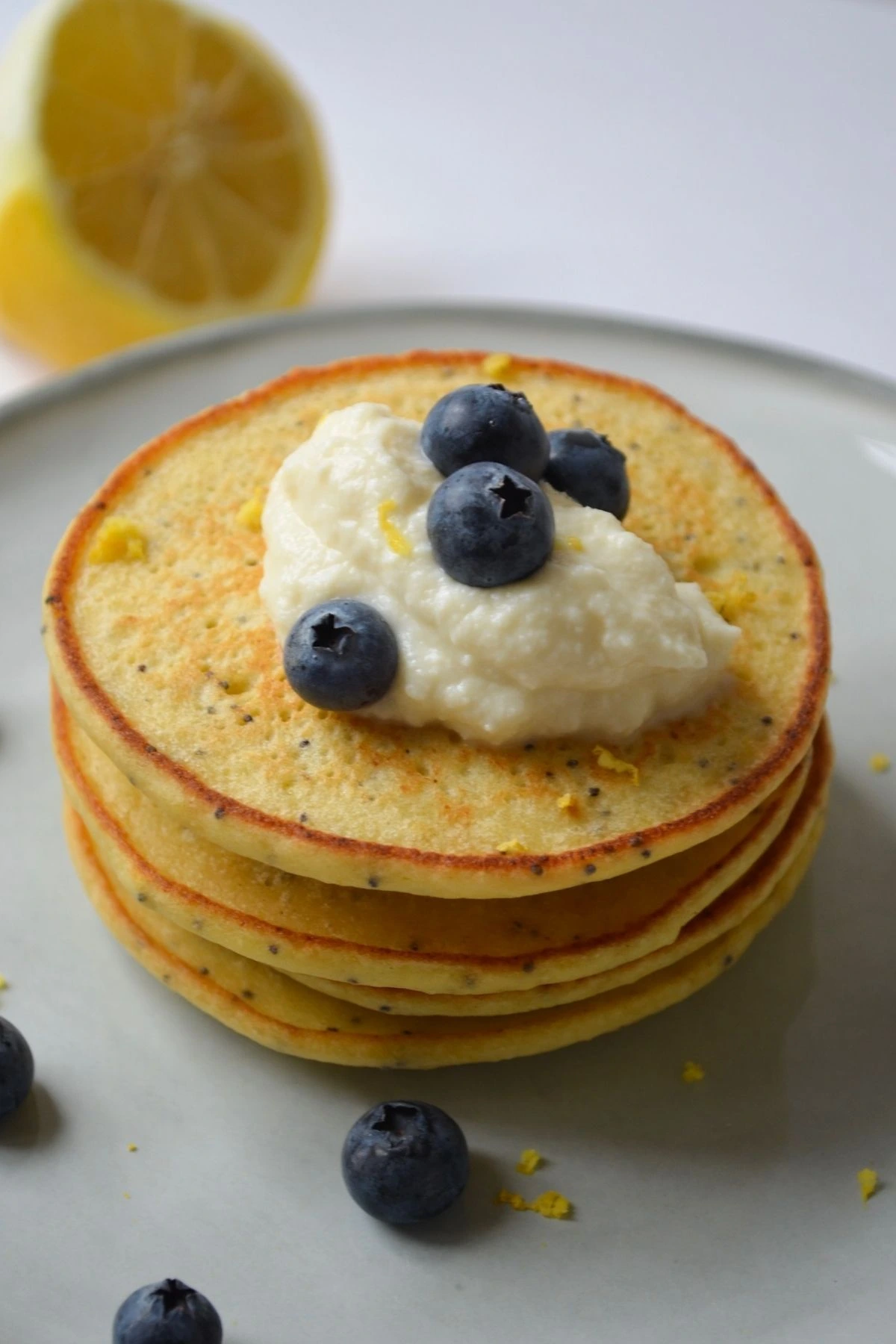 Lemon pancakes, topped with whipped ricotta and blueberries