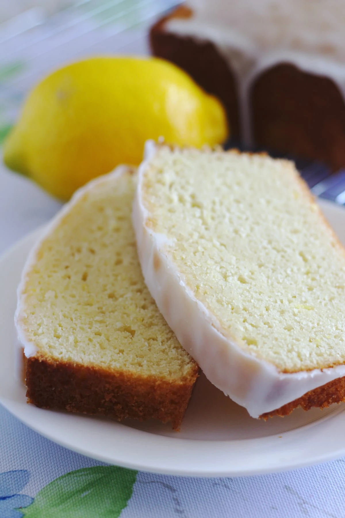 Two slices of lemon cake served on a white plate