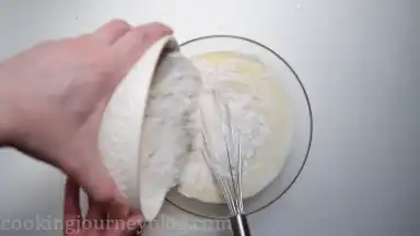 Add half of flour to the liquid batter. Whisk together.