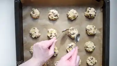 Using wet fingers or two teaspoons, press and form the cookies from the balls.