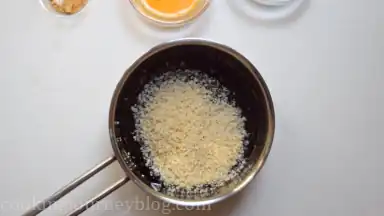 Slightly heat the syrup in the pan. Add in breadcrumbs.