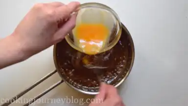 Slowly whisk in beaten egg.