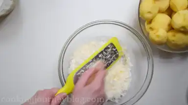 Grate the cheese in the large bowl.