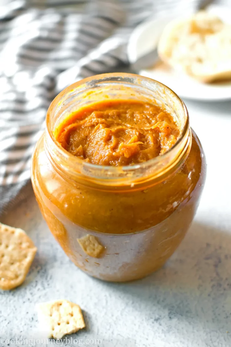 A jar with sweet potato butter, served with crackers