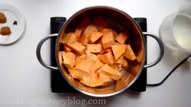 Put peeled and cut into smaller pieces sweet potatoes in a large pot.