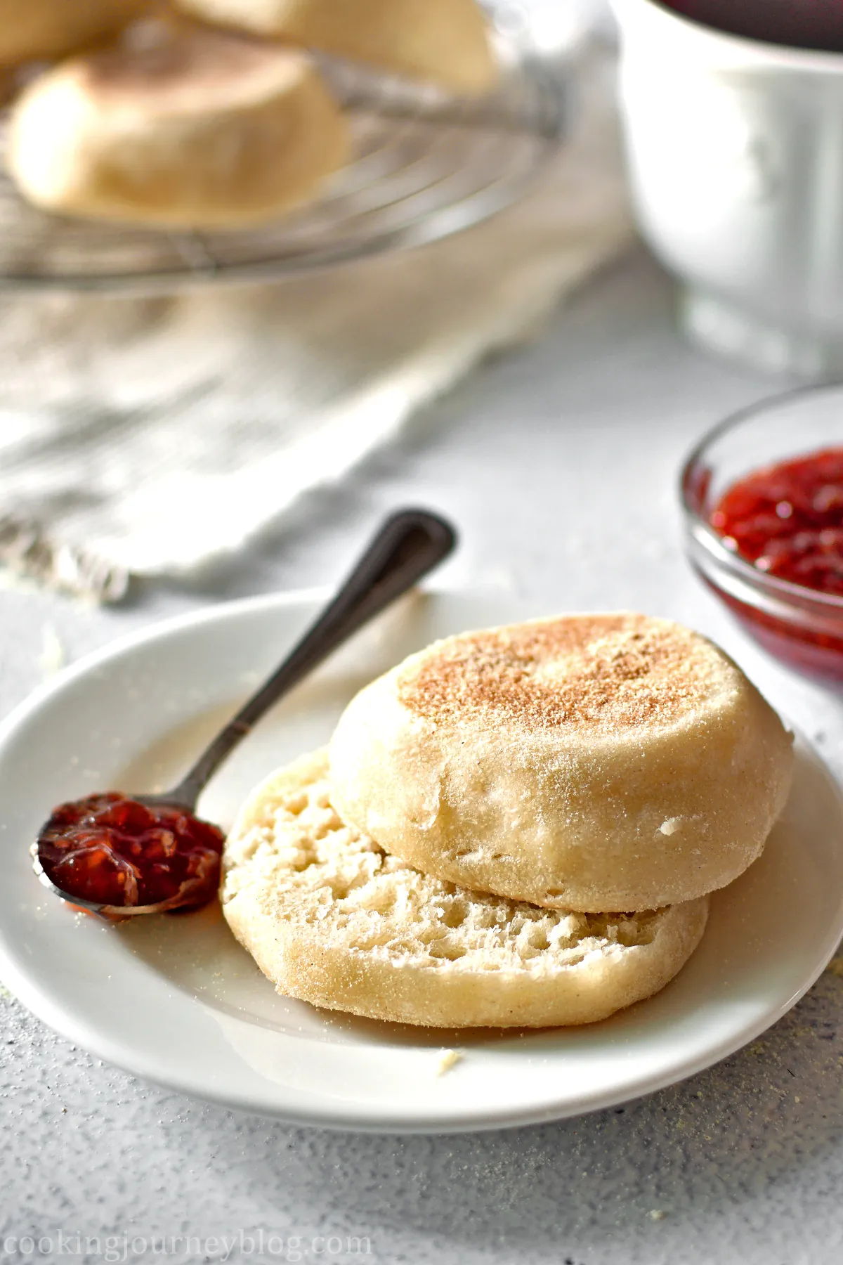 vegan English muffin, cut in half and served with a spoon with jam