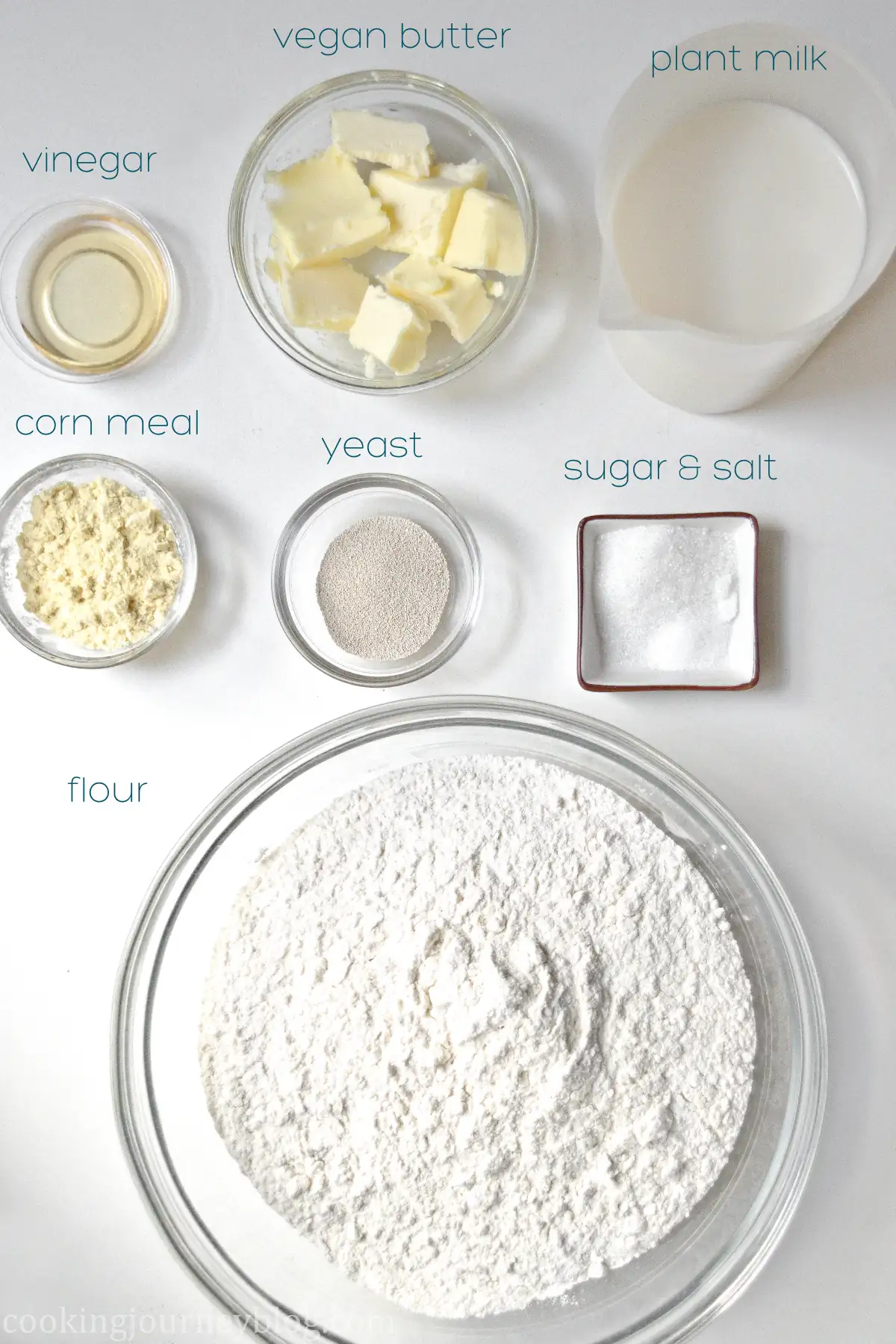 Ingredients for vegan English muffins: vinegar, butter, milk corn meal, yeast, sugar and salt, flour