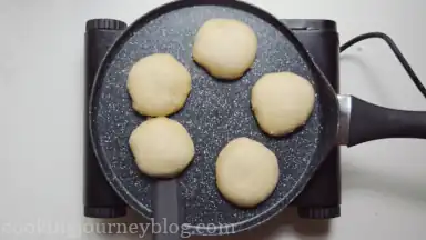 Heat the pan and cook vegan English muffins on one side until crispy and puffed, around 5 minutes.