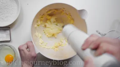 Beat butter with sugar until white. Scrap the sides of the bowl with a spatula.
